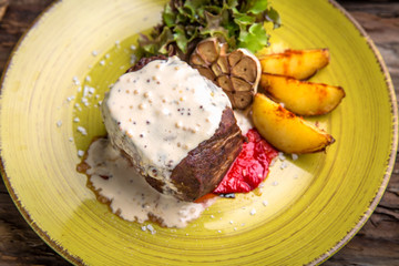 Neck steak, tenderloin or filet mignon pork or beef. Juicy tasty piece of meat. Delicious juicy steak.  A big piece of grilled meat.