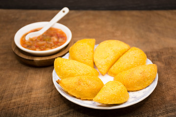 Colombian empanada with spicy sauce