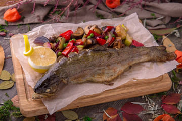 Grilled sturgeon, carp, crucian, or trout with vegetables on wooden table. Beautiful stylish menu. Free space for text