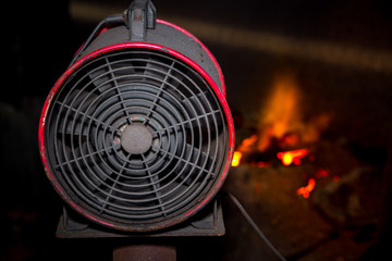 Industrial fan using hot scrap steel melting furnace in a local steel machine parts making yard Bangladesh.