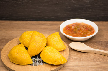 Colombian empanada with spicy sauce