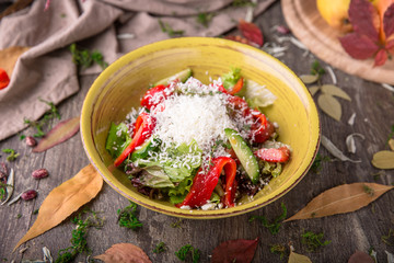 Nutritious, vitamin, healthy salad of fresh tomatoes, cucumbers, olives, peppers and country cheese.  Rustic Still Life
