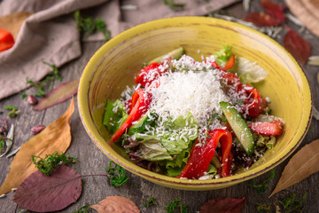 Nutritious, vitamin, healthy salad of fresh tomatoes, cucumbers, olives, peppers and country cheese.  Rustic Still Life