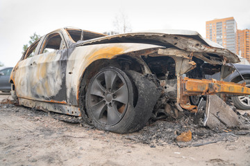 Fototapeta premium car after deliberate arson. destroyed vehicle after a fire melted is on the street.