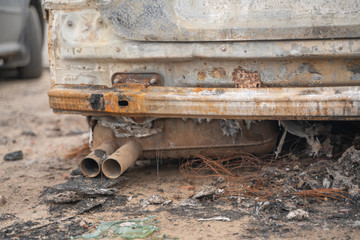 car after deliberate arson. destroyed vehicle after a fire melted is on the street.