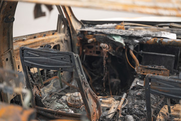 car after deliberate arson. destroyed vehicle after a fire melted is on the street.