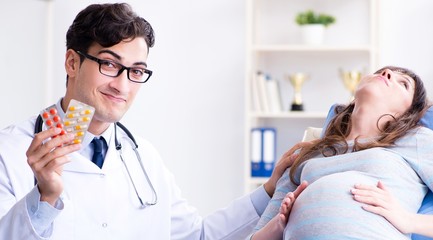 Fototapeta premium Pregnant woman visiting doctor for consultation