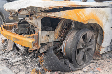 Fototapeta premium crushed melt car after deliberate arson. destroyed vehicle after a fire melted is on the street.