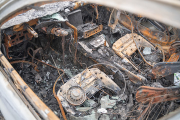 Fototapeta na wymiar car after deliberate arson. destroyed vehicle after a fire melted is on the street.