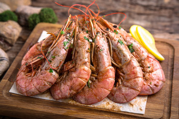 Grilled Shrimp on wooden table. Beautiful stylish menu. Free space for text