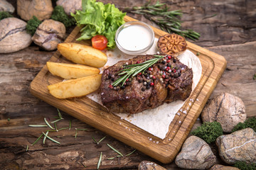 Neck steak, tenderloin or filet mignon pork or beef. Juicy tasty piece of meat. Delicious juicy steak.  A big piece of grilled meat.