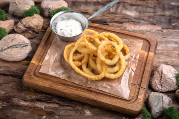 Crunchy Deep fried squid ring in batter with a delicious sauce. Beautiful stylish menu. Autumn still life. Free space for text