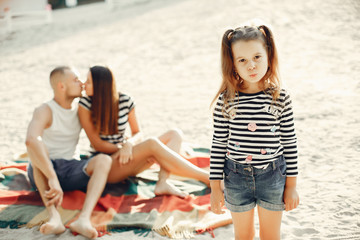 Family in a summer park. Mother and little daughter playing. Cute little girl with a father