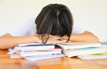 exam stress - education young female college in class taking notes and using a pencil sitting learning concept stressed student girl asian take the exam final  and sleeping on books