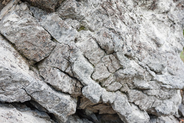 Stones close-up. The structure of the stone. Large stones lie on the shore. Gray stones in the cracks.