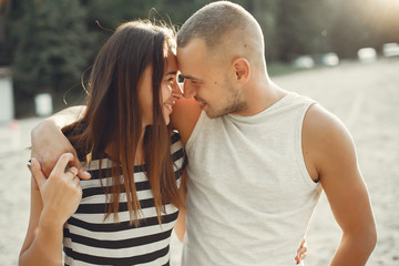 Couple in a park. Woman in a t-shirt. Man with his wife