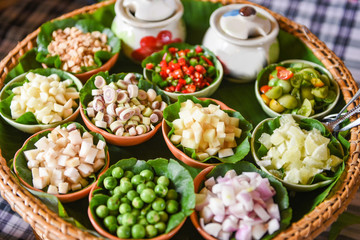 Savoury Leaf Wraps herbs and spices ingredients spicy soup fresh vegetables for Tom Yum thai with slice piece lemon grass garlic galangal chilli lime  tomato shallot peanut on tray Thai Food Asian
