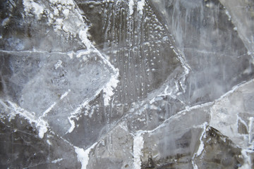 protrusions of white salts are on a black stone. abstract texture