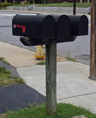 Three Black Metal Mailboxes at the Side of the Road