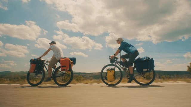 Two guys cycling in a row on the countryside