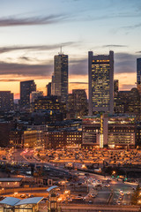 Boston city skyline at sunset with large parking lot in the foreground