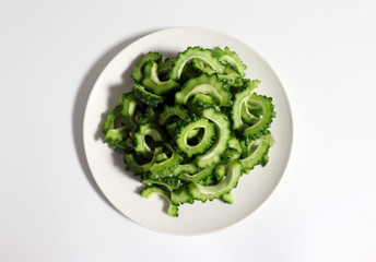 Obraz premium Bitter gourd slice on white dish.