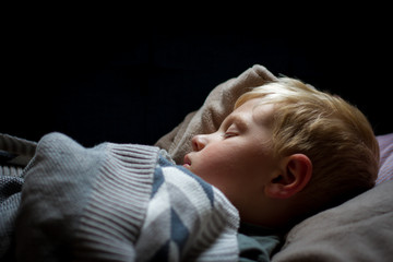 Sleeping boy with blanket and pillow