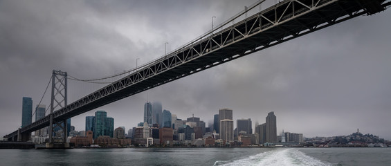 Fototapeta na wymiar San Francisco skyline with bay bridge on overcast day in color