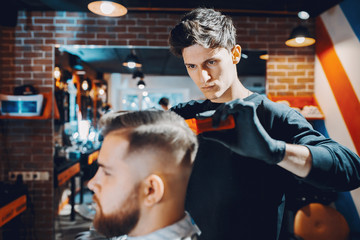 Man with a beard. Hairdresser with a client.