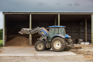 Farm tractor on the farm in rural countryside