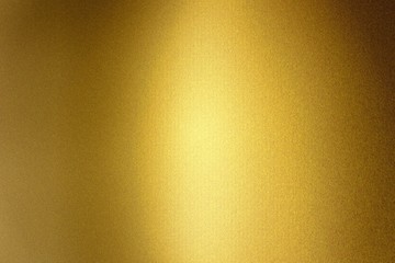 Light shining on gold metallic foil wall, abstract texture background