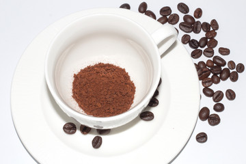 cup of coffee with beans isolated on white background