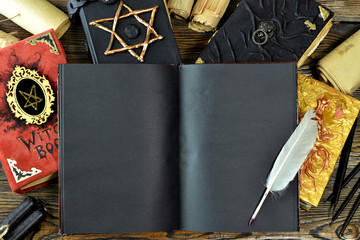 Open book diary with blank empty pages and evil manuscripts on witch table.