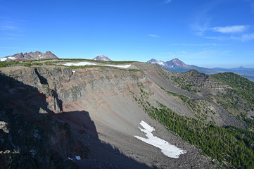 View of Broken Top and Three Sisters volcanoes from Tam McArthur Rim Trail in Three Sisters Wilderness near Sisters, Oregon on a clear summer morning.