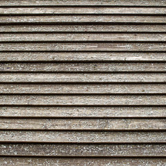 old gray brown beige wooden surface with peeling paint and horizontal lines. rough texture