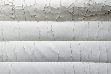 Close-up old cracked white leather of luxury cushion