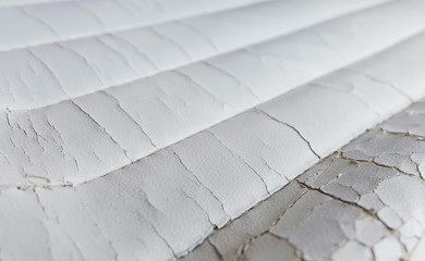 Close-up old cracked white leather of cushion