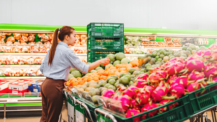 Asian women shopping Healthy food vegetables and fruits in supermarket