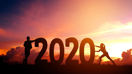 2020 Newyear  Couple tries to push number of 2020 Happy new year concept