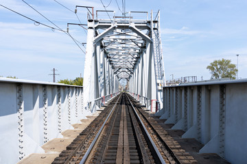 Empty long railway metallic bridge with rails. sunny day