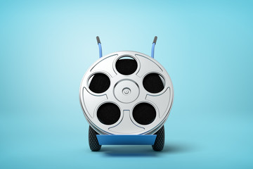 3d close-up rendering of film reel on blue hand truck on light-blue background.