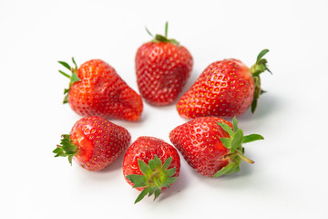 Ripe appetizing strawberries on a white background.