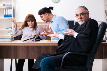 Young couple in the courthouse in divorce concept