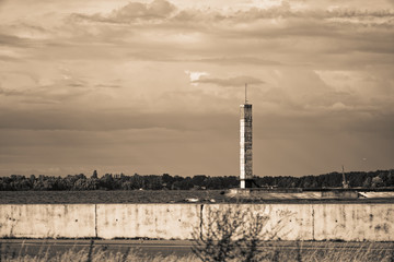 Lighthouse or old beacon under storm clouds