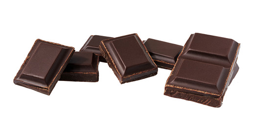 Dark chocolate pieces isolated on white background.