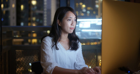 Asian Woman working over night on computer