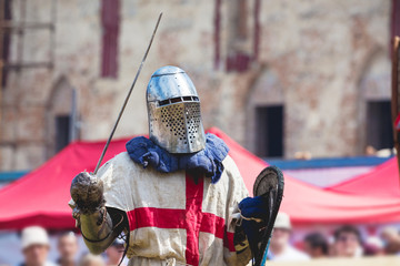 A medieval knight with a weapon is ready to fight_