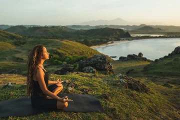 Foto op Canvas Woman doing yoga alone at sunrise with mountain and ocean view. Harmony with nature. Self-analysis and soul-searching © Oleg Breslavtsev