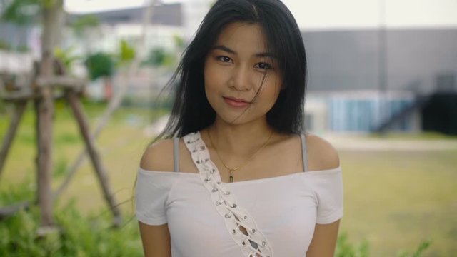 Portrait of cute Thai Girl outdoors. Slow motion