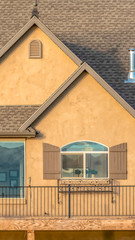 Vertical frame Home exterior with spacious balcony dark roof brown wall and shiny windows